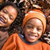 Siblings lying on the ground and smiling