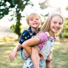 Brother riding on his sister' back