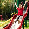 Boy sliding down on the slide