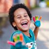 Boy with painted hands laughing