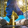 Boy steps in blue sneakers