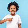 Boy smiling and pointing at himself