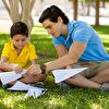 Father and son folds a plane