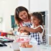 Mother and daughter baking a cake