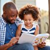 Father and daughter reading a book