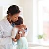 Doctor examining the baby with a stethoscope