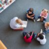 Teacher reading book loudly for students