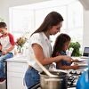 Mother and father teaching the children in kitchen