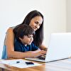 Mother and son using laptop