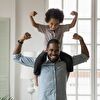 Son sitting on father's neck