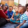 Teacher showing a book for children