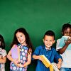 Students holding books in their hands and smiling