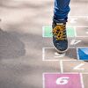 Kid playing hopscotch