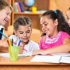 Children laughing and writing