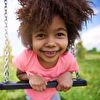 Closeup Girl Smiling in Pink on Swing